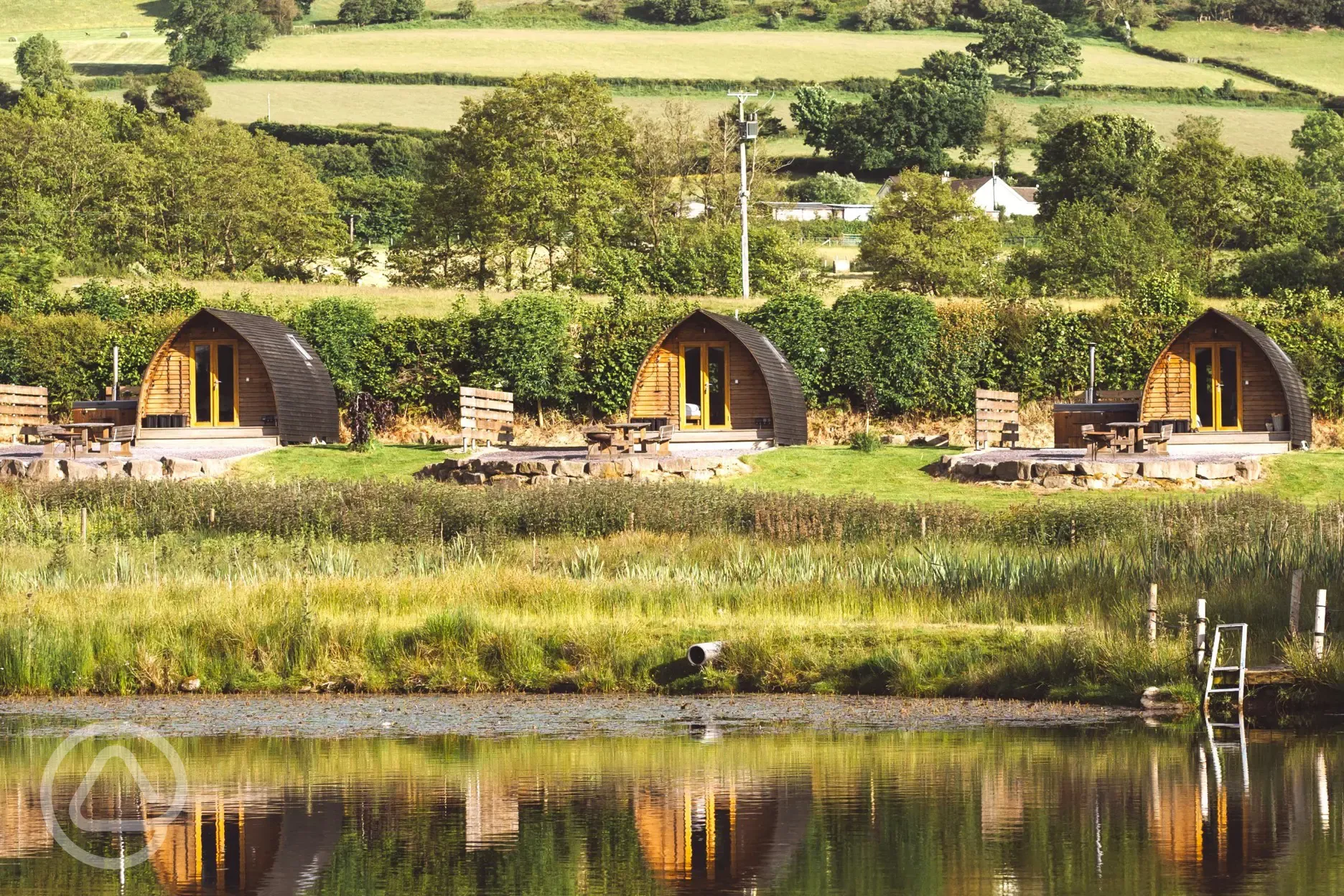 Deluxe Wigwam pods by the lake