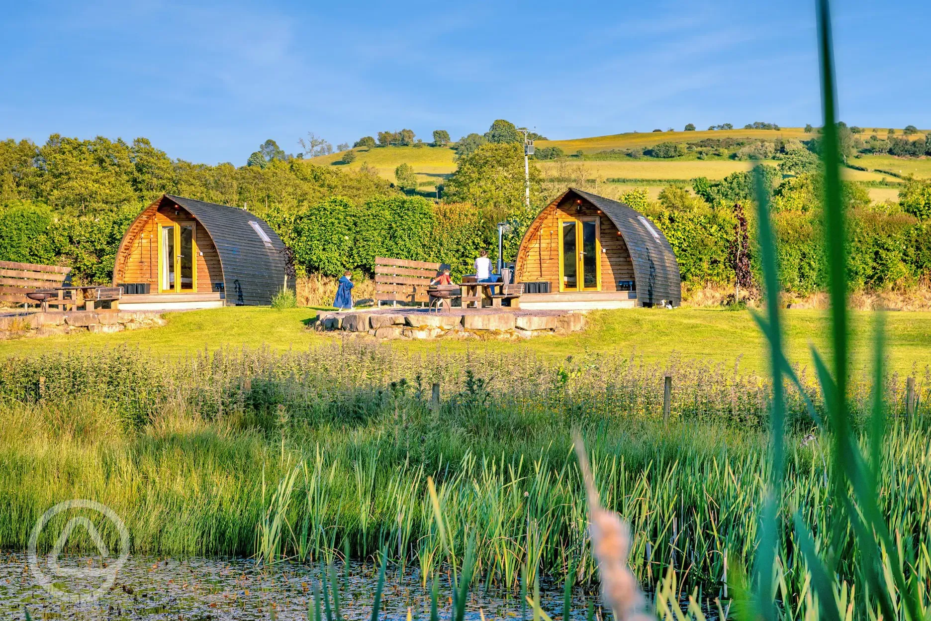 Glamping pods with views of the lake where guests can swim and kayak