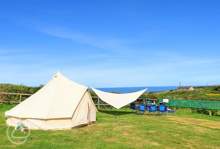 Bell tent pitched on a sea view non electric grass pitch