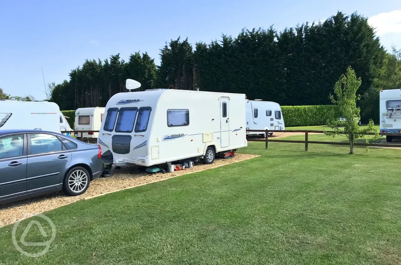 Hardstanding touring pitches with small fences to divide areas