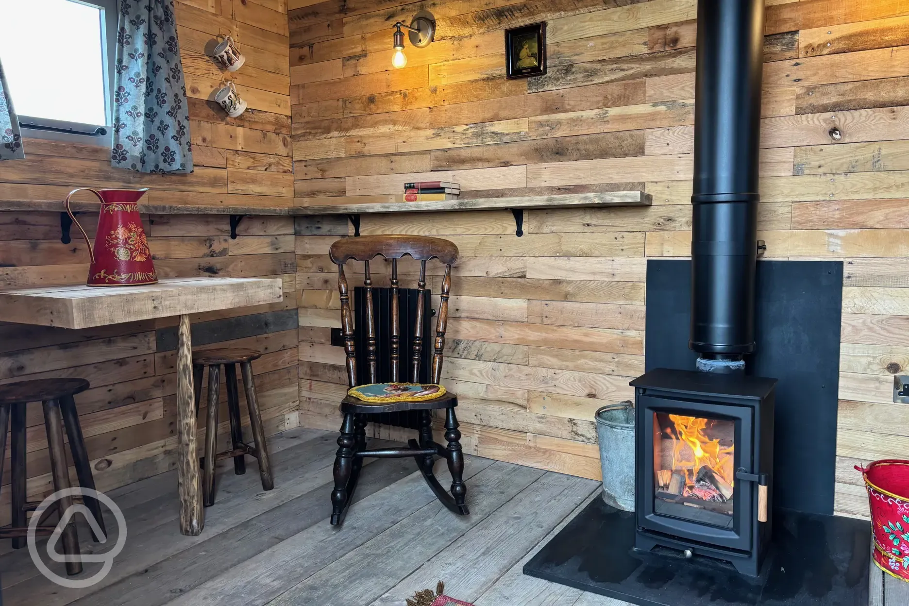 Shepherd's hut interior with a log burner