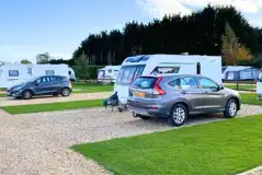 Hardstanding touring pitches with grass areas between Hardstanding touring pitches with grass areas between