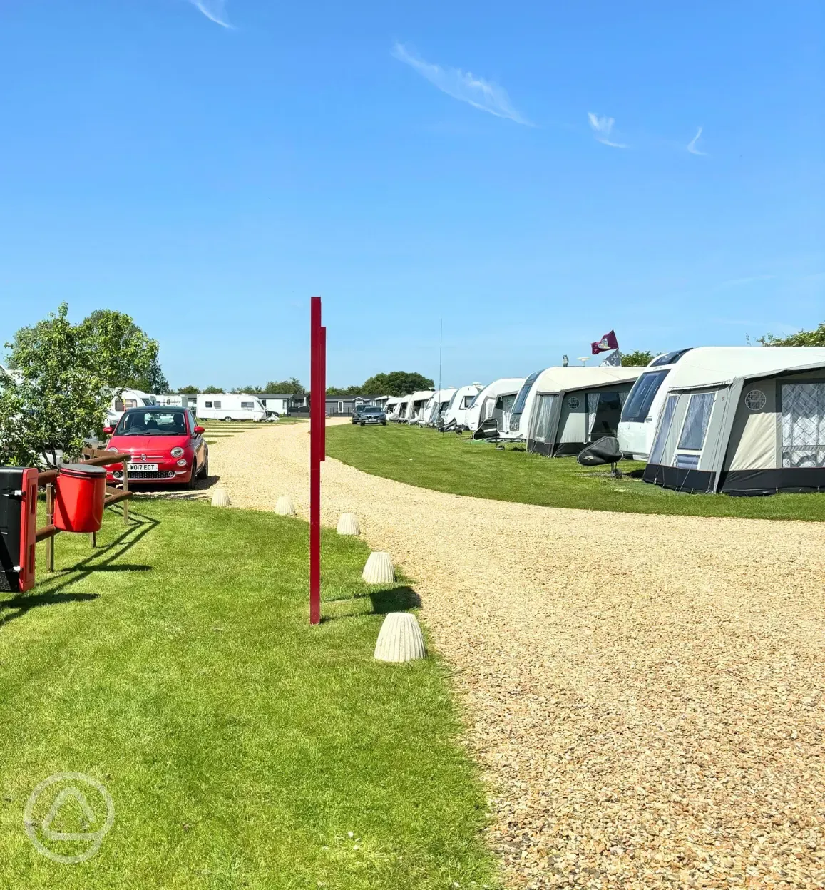 Hardstanding touring pitches with a gravel road between