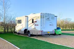 Hardstanding touring pitches with grass areas between Hardstanding touring pitches with grass areas between
