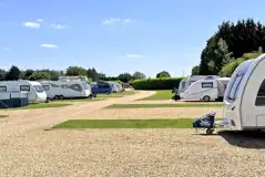 Hardstanding touring pitches with grass areas between Hardstanding touring pitches with grass areas between