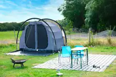 Close up of a tent on an electric grass pitch
