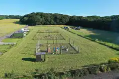 Electric grass tent pitches with a view of animal coups