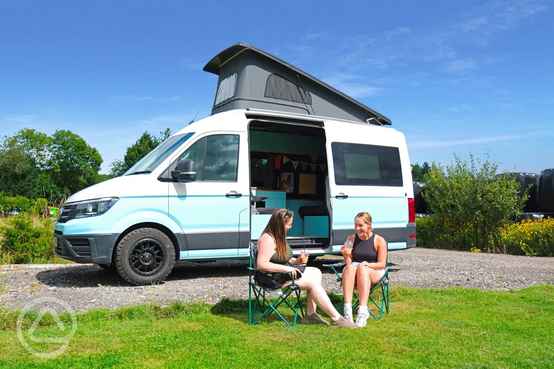 VW campervan on an electric hardstanding pitch