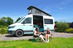 VW campervan on an electric hardstanding pitch