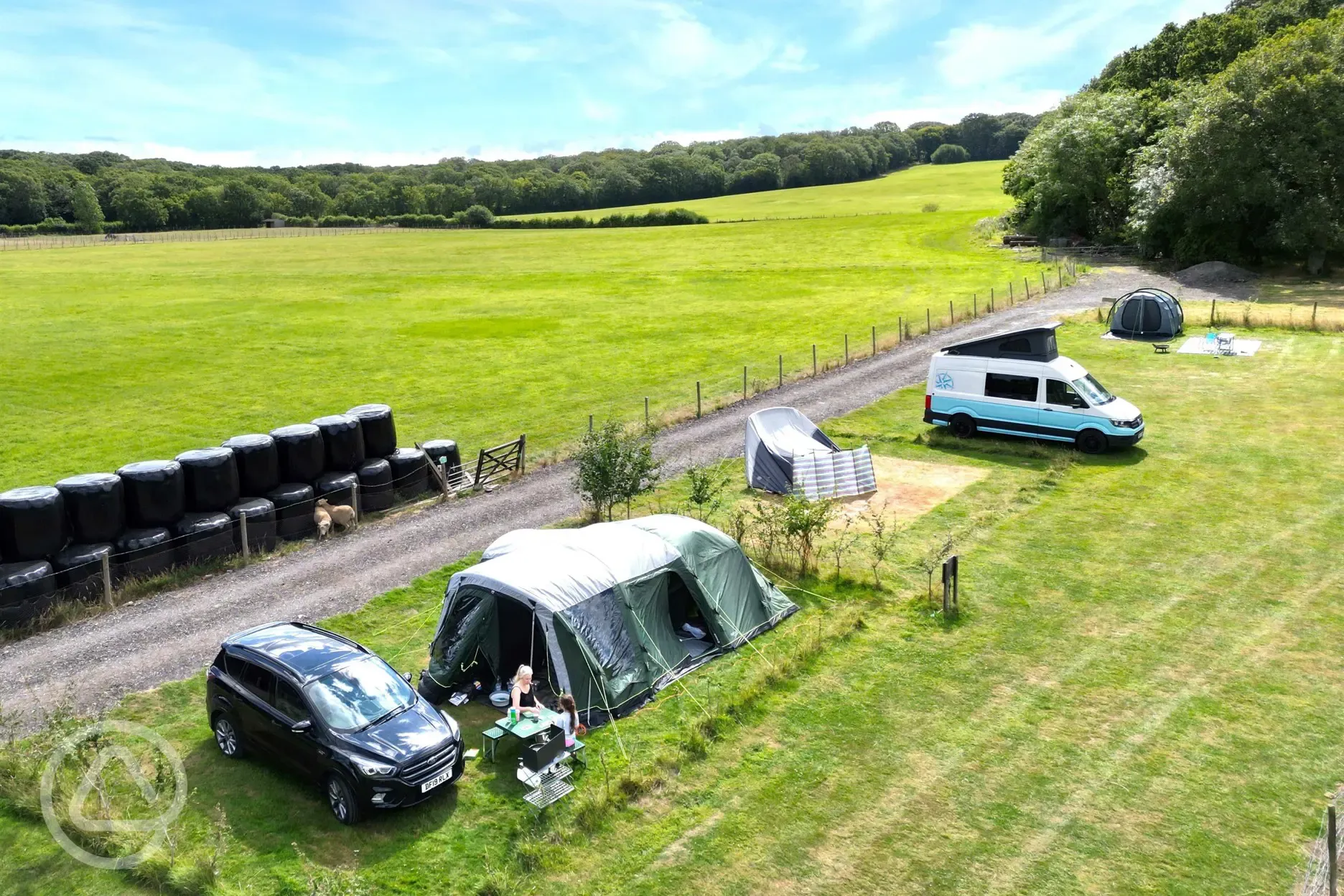 VW campervan and tent on the electric grass pitches