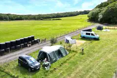 VW campervan and tent on the electric grass pitches
