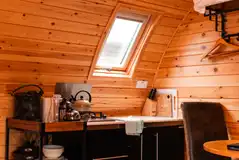 Camping pod kitchen area with a gas hob, fridge and ice box Camping pod kitchen area with a gas hob, fridge and ice box