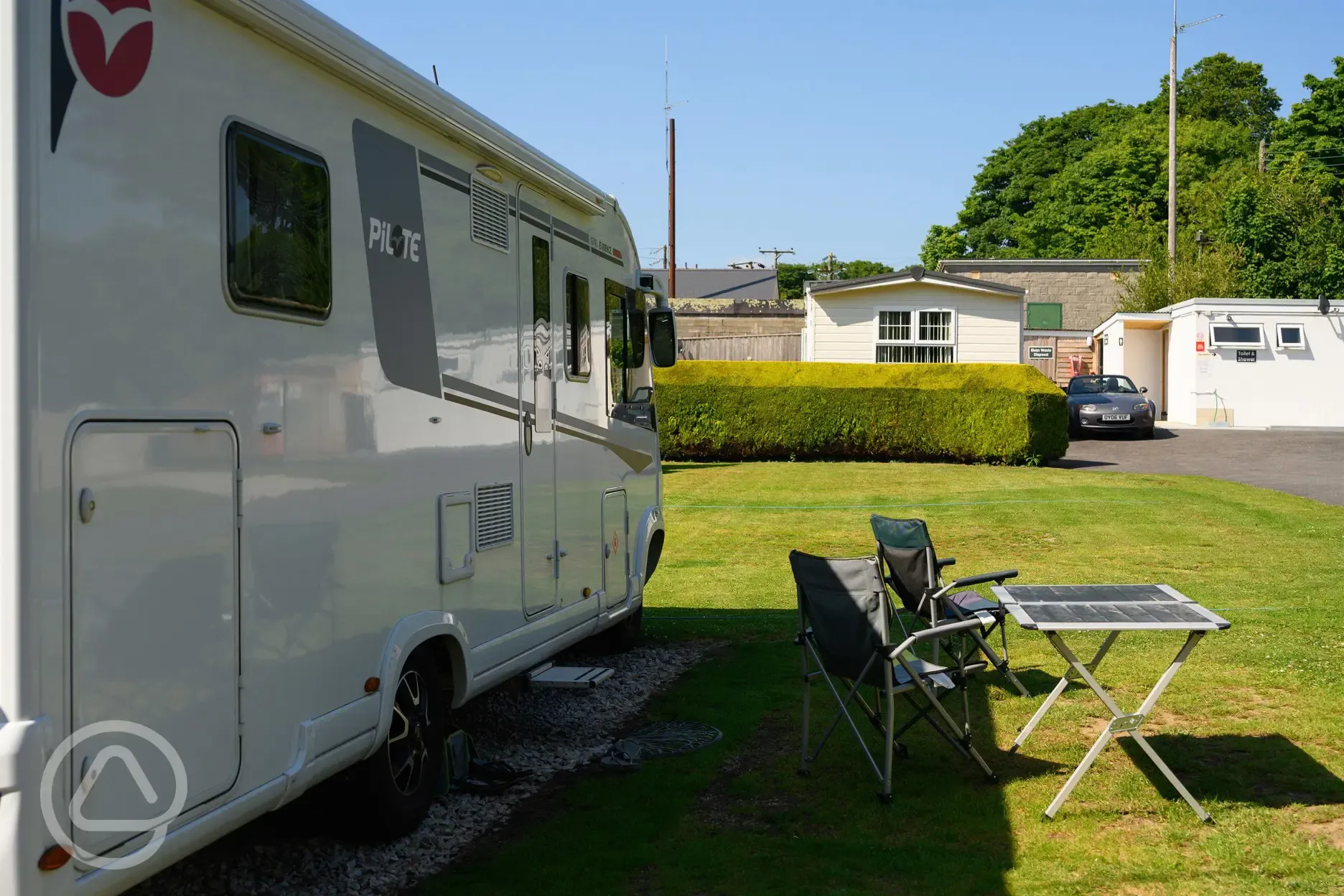 Electric hardstanding with grass pitches