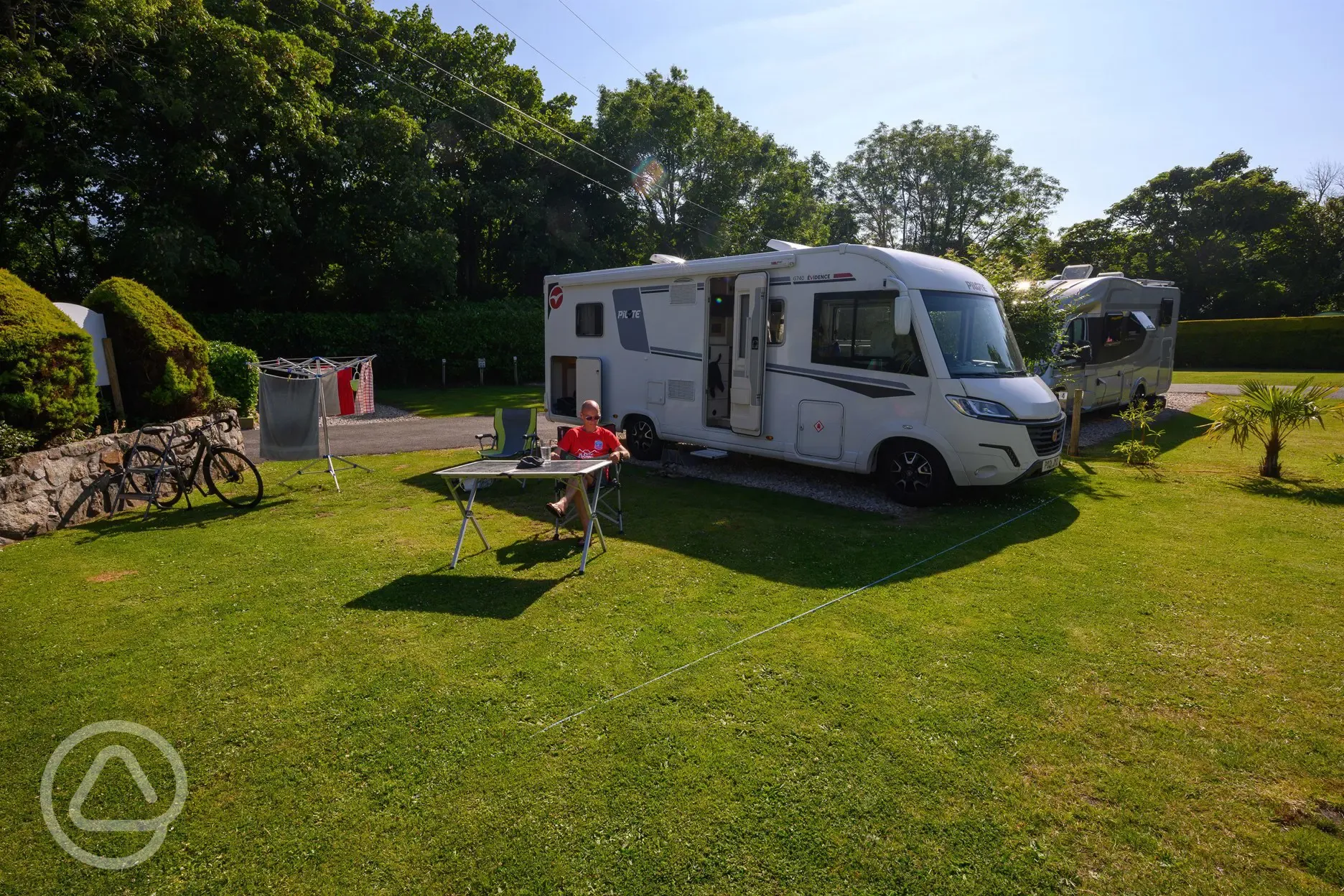 Electric hardstanding with grass pitches