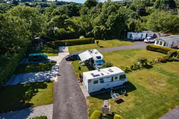 Aerial of the electric hardstanding with grass pitches at Stream Valley