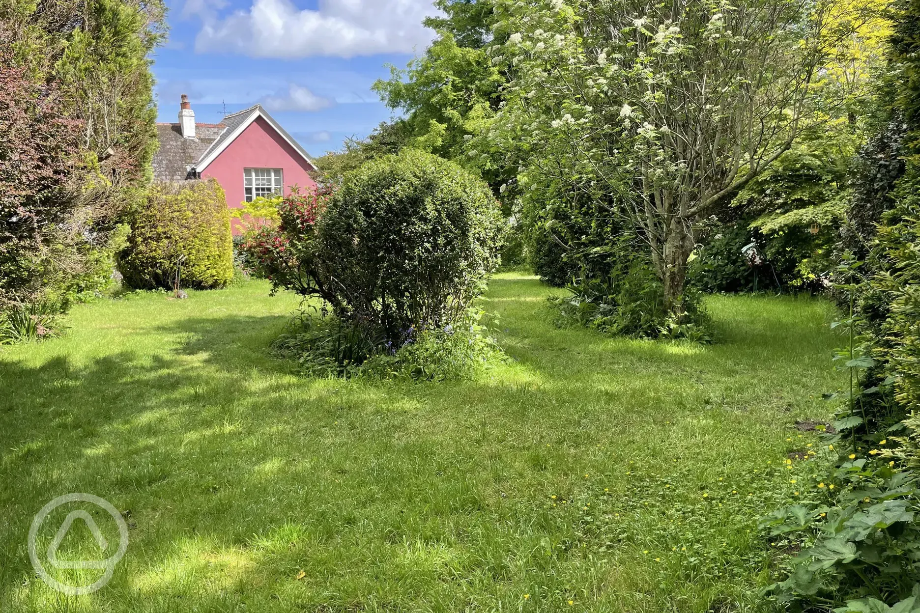 Non electric grass pitches amongst apple orchard