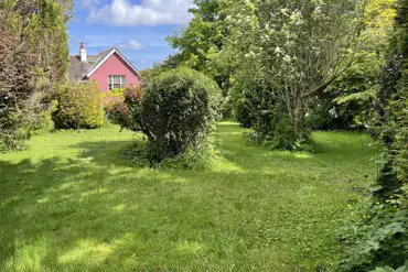 Non electric grass pitches amongst apple orchard