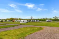 Electric hardstanding and grass pitches, set across four fields Electric hardstanding and grass pitches, set across four fields
