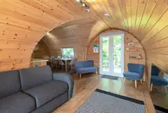 Llys y Llwynogod living and dining area with a double sofa bed and TV