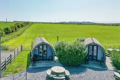 Aerial of Cennin Pedr and Pabi glamping pods with hot tubs