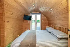 Llys y Llwynogod double bedroom with glass doors and TV