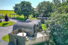 Llys y Llwynogod five person pod with an outdoor deck and hot tub