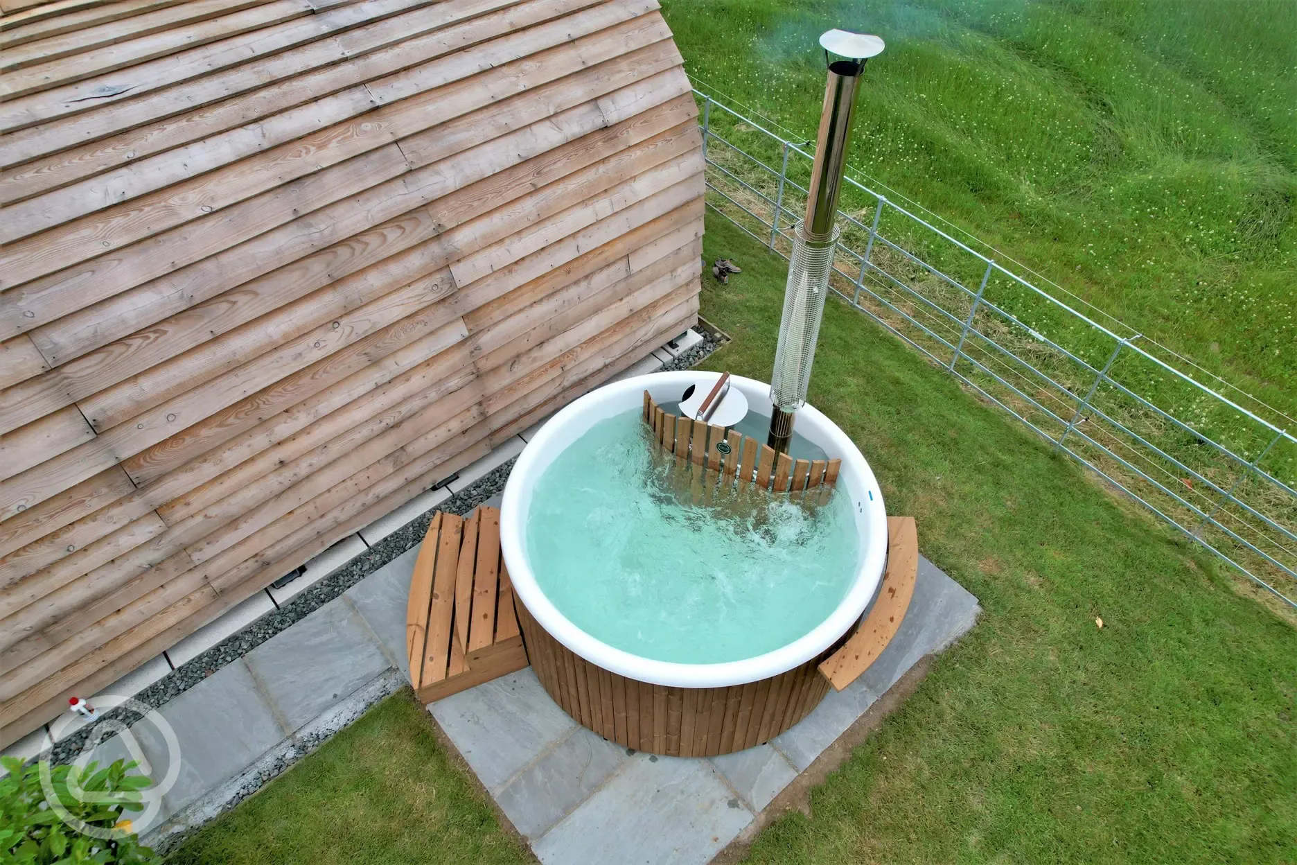 Glamping pod with a wood-fired hot tub at Pods Pwll Coch