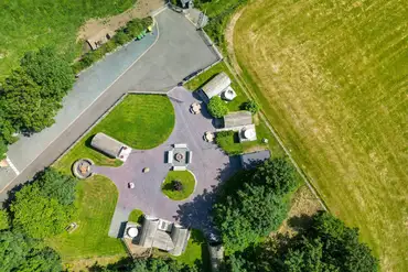 Bird's eye view of Pods Pwll Coch with a central fire pit