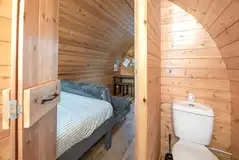 Four person pod ensuite bathroom with a toilet, shower and hand basin