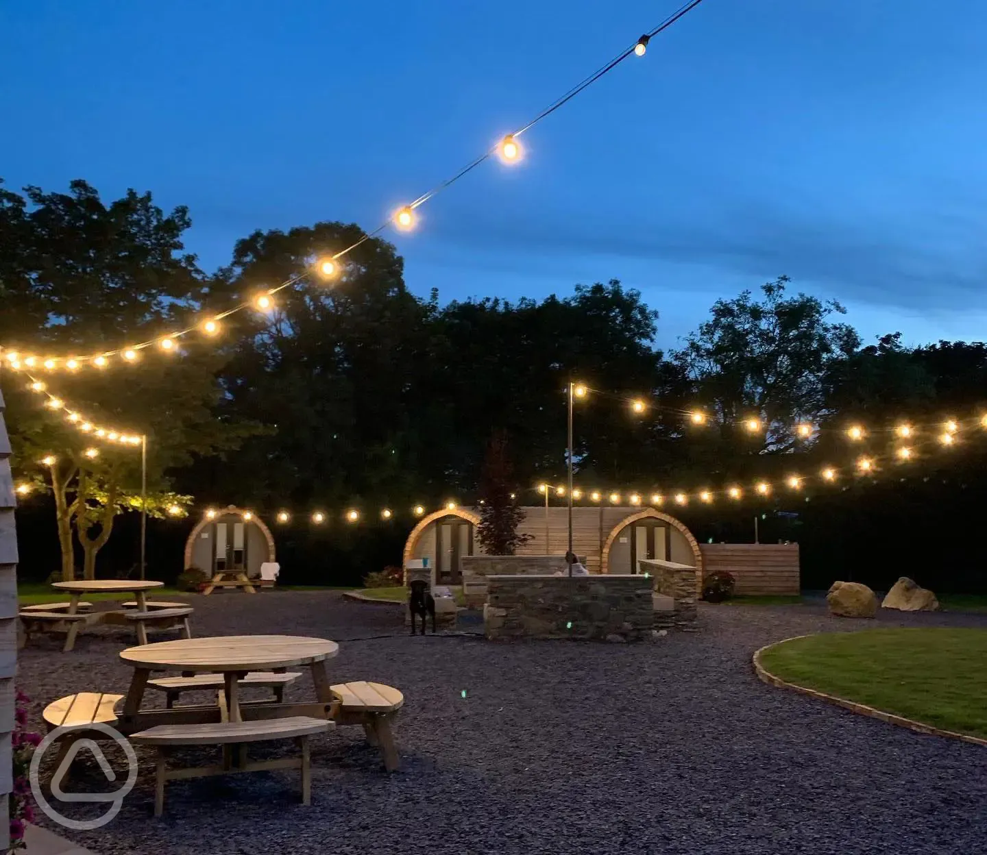 Glamping pods lit up at night