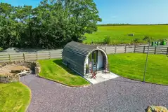 Clychau'r Gog glamping pod with outdoor furniture and a picnic area