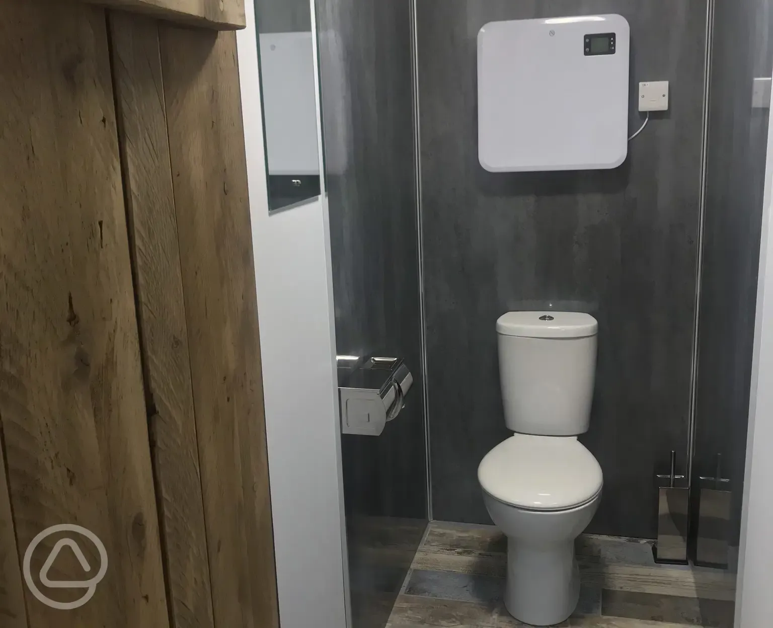 A separate toilet with wall heater.