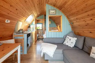 Ensuite glamping pod interior with fold out settee