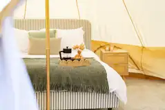Woodland 6m bell tents with a king sized bed and two single futon beds