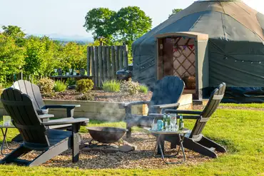 Yurt with a fire pit and seating area