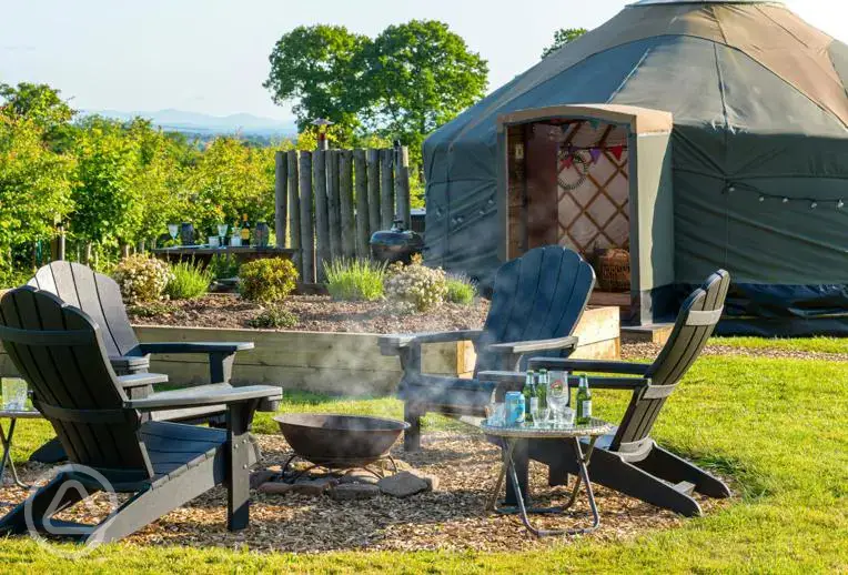 Yurt with a fire pit and seating area