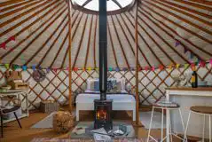 Yurt interior with a double bed and two optional single beds Yurt interior with a double bed and two optional single beds