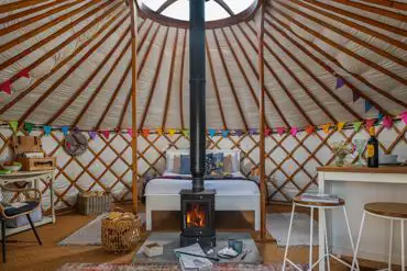 Yurt interior with a double bed and two optional single beds