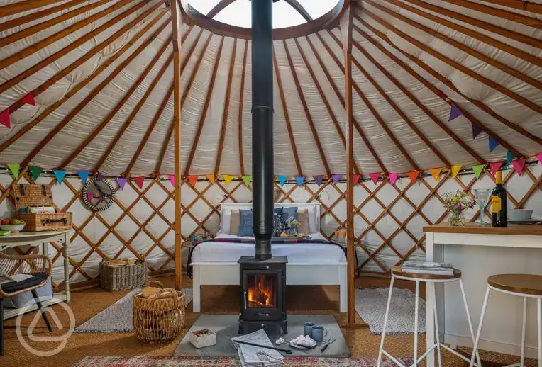 Yurt interior with a double bed and two optional single beds