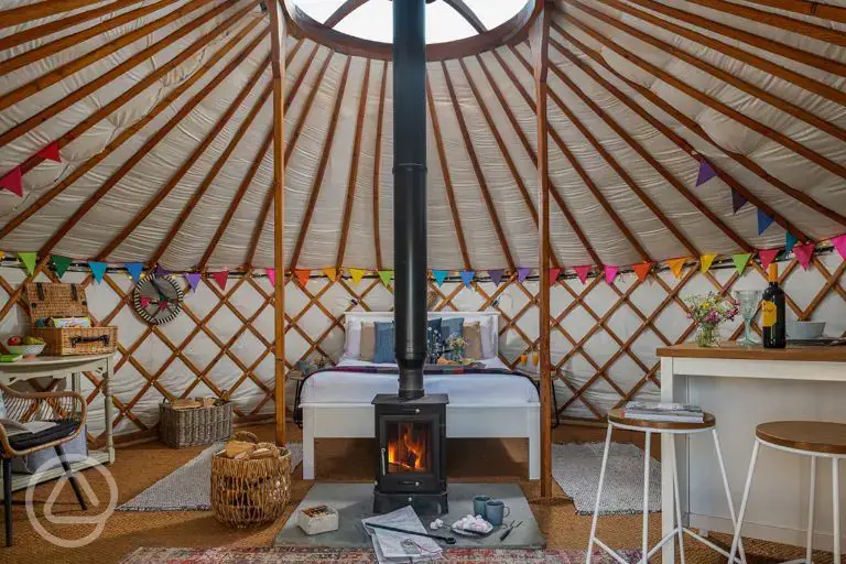 Yurt interior with a double bed and two optional single beds