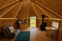 Cabin interior with double sofa bed, log burner and kitchenette Cabin interior with double sofa bed, log burner and kitchenette
