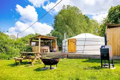 Yurt with a private hot tub, fire pit and covered kitchen at Glamp and Tipple
