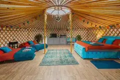 Yurt (sleeps 2-8) interior with a king bed, two double futon and two Z-beds