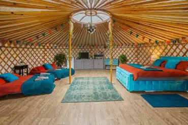 Yurt (sleeps 2-8) interior with a king bed, two double futon and two Z-beds