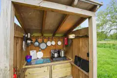 Private outdoor kitchen with a camp stove and cooking equipment