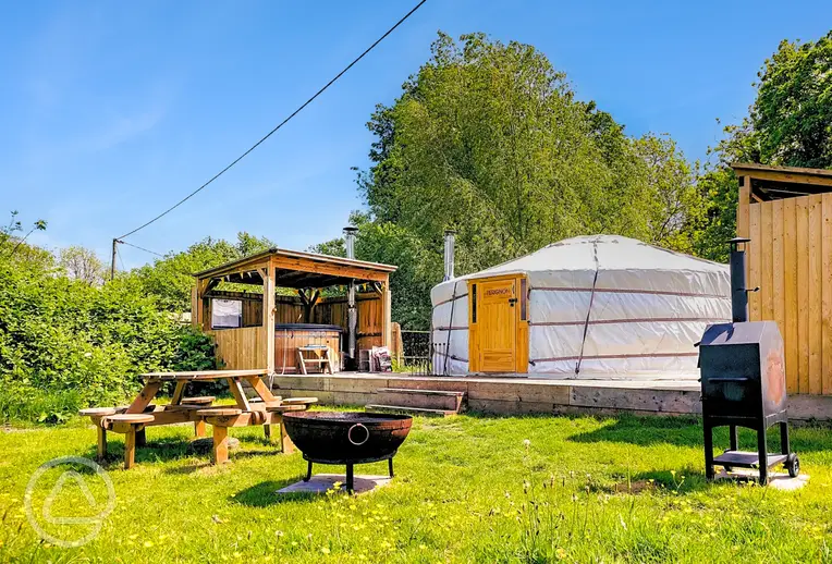 Yurt with a private hot tub, fire pit and covered kitchen at Glamp and Tipple