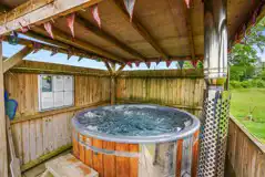 Private wood-fired covered hot tub at Glamp and Tipple