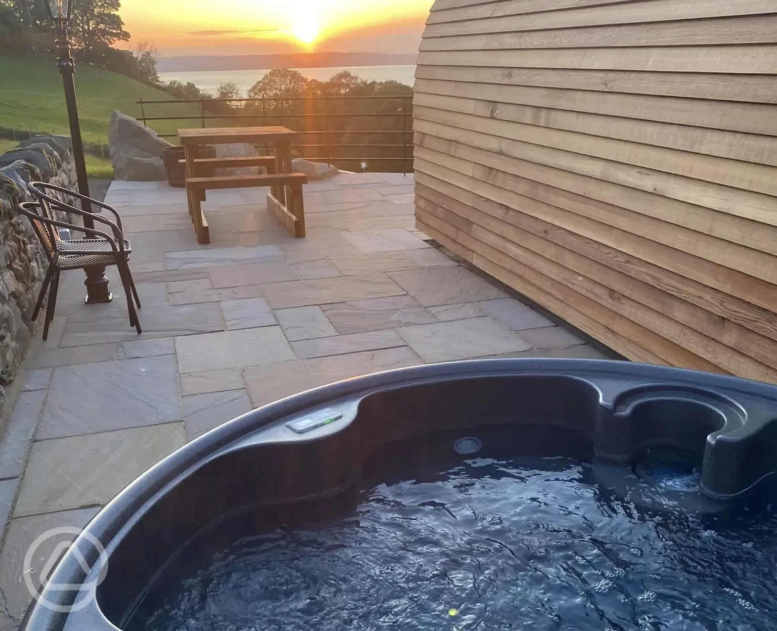 Large glamping pod hot tub and patio area 