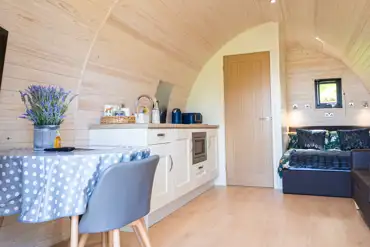 Large glamping pod double bed, dining area and kitchen