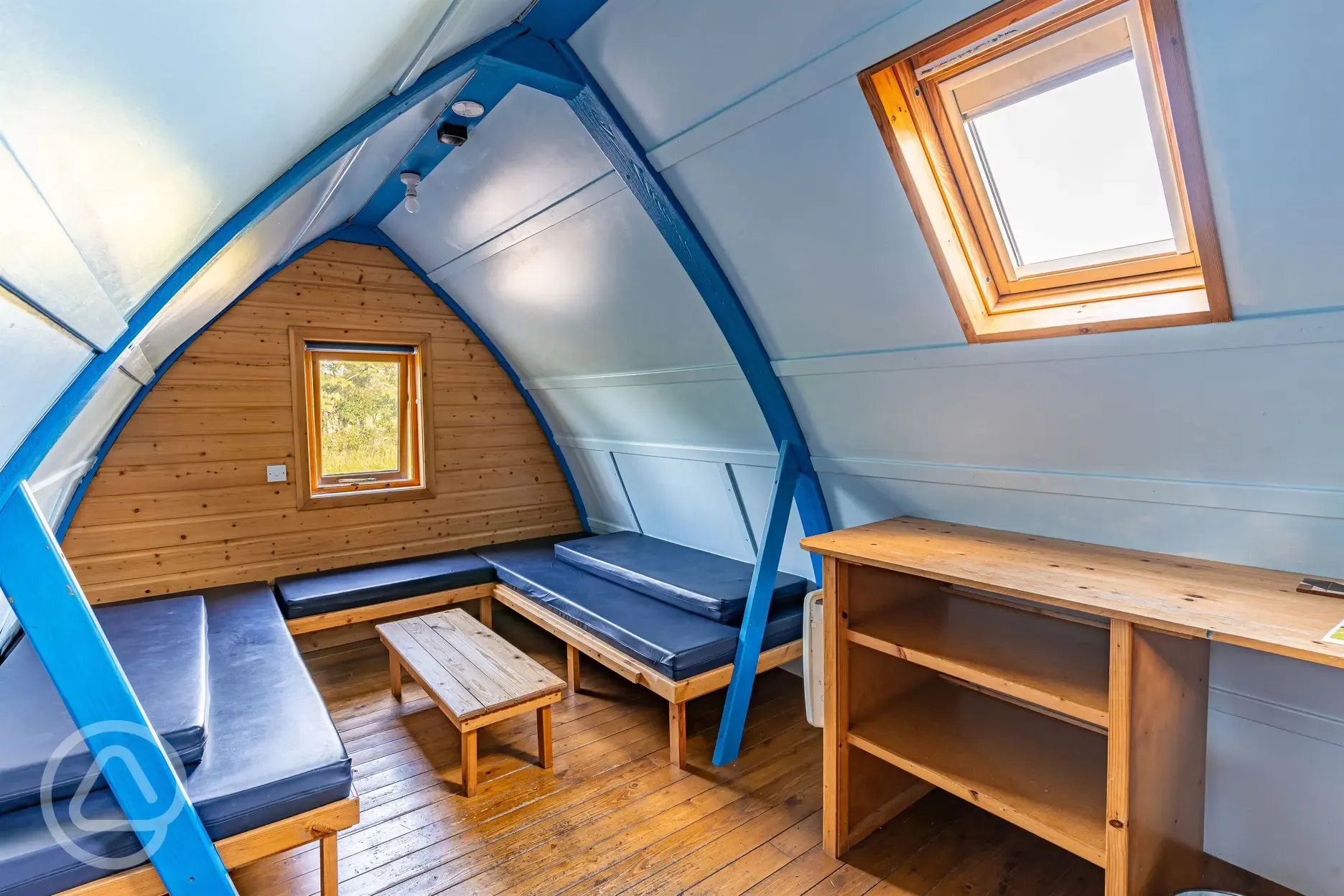 Glamping pod interior- benches with comfy mattresses for sleeping and sitting